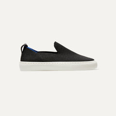 side | The Kids slip-on Sneaker in Black shown from a side view showing the outsole.