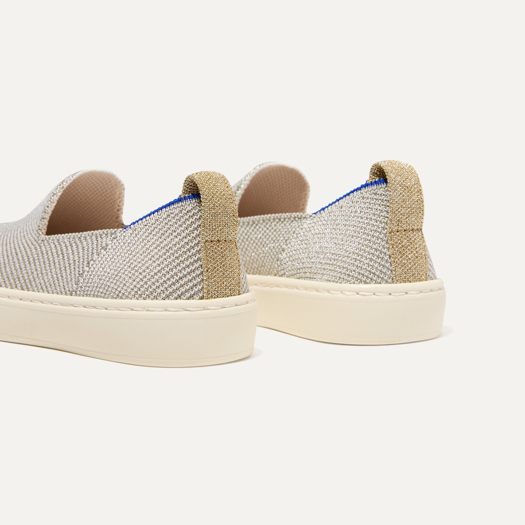 Close up of the heel of The Kids Sneaker in Diamond Twill, with shimmery gold pull tab.