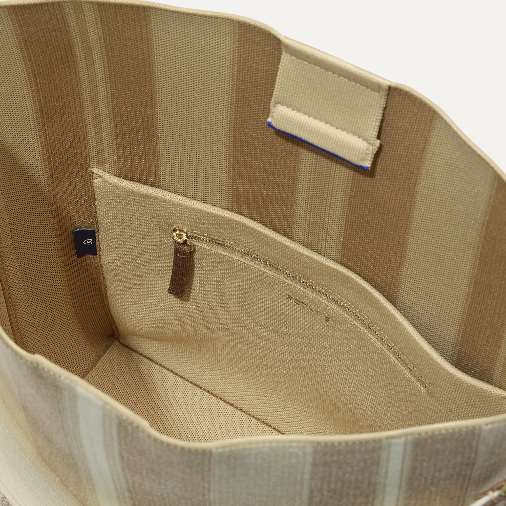 The Bucket Bag in Oat Latte close up of interior zipper pocket.