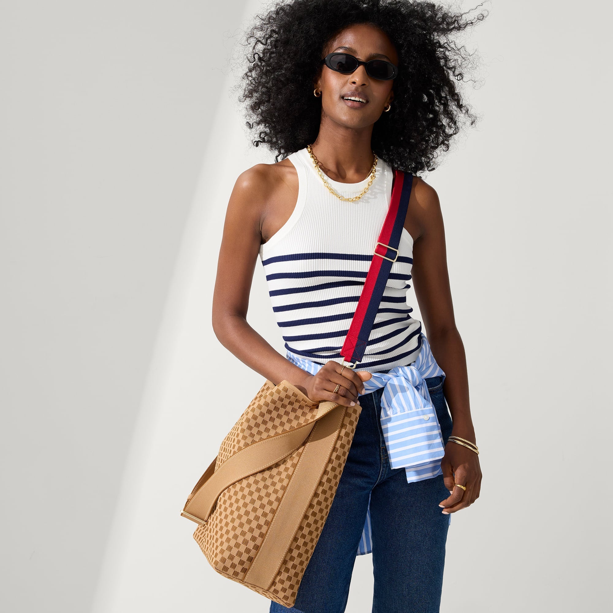 model | Overlay:: Shown with The Crossbody Strap (sold separately). | Alt:: An alternate image of a model wearing The Bucket Bag in Hazelnut.