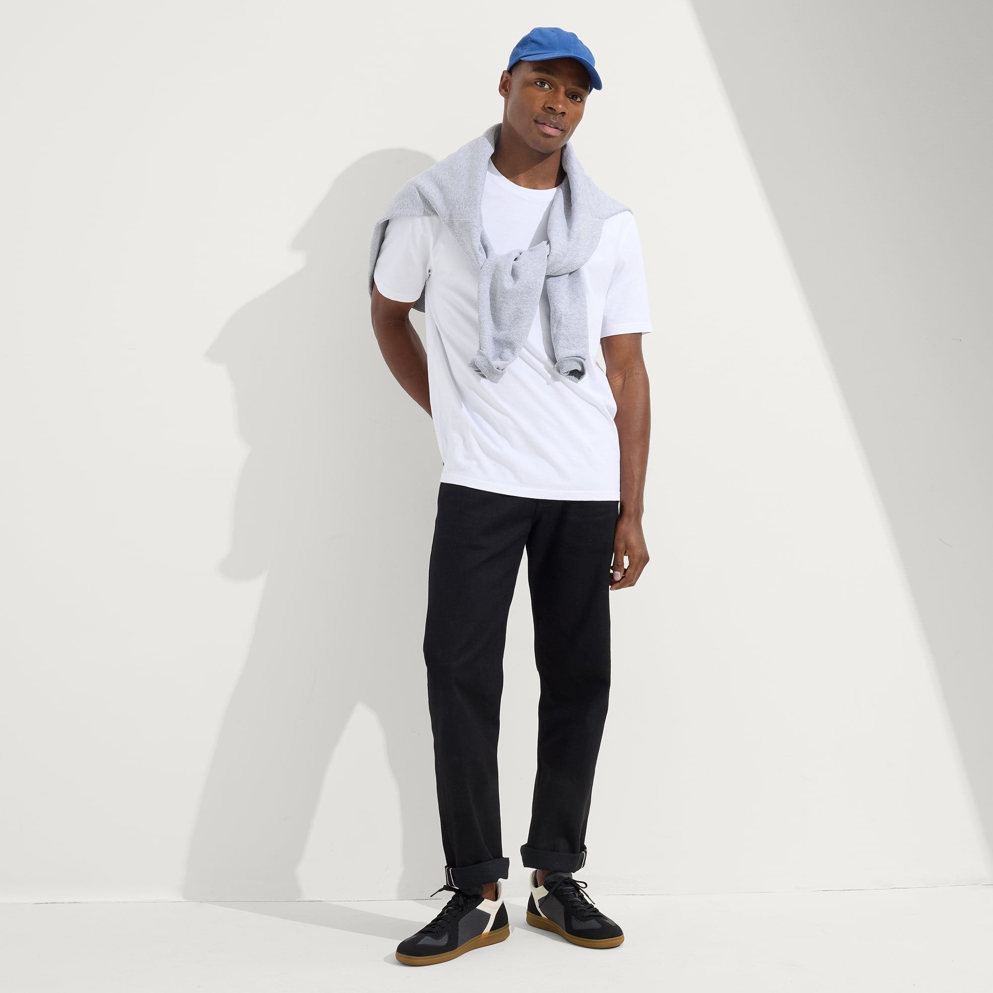 model | Alternate view of a model wearing The RS01 Sneaker in Obsidian Black.