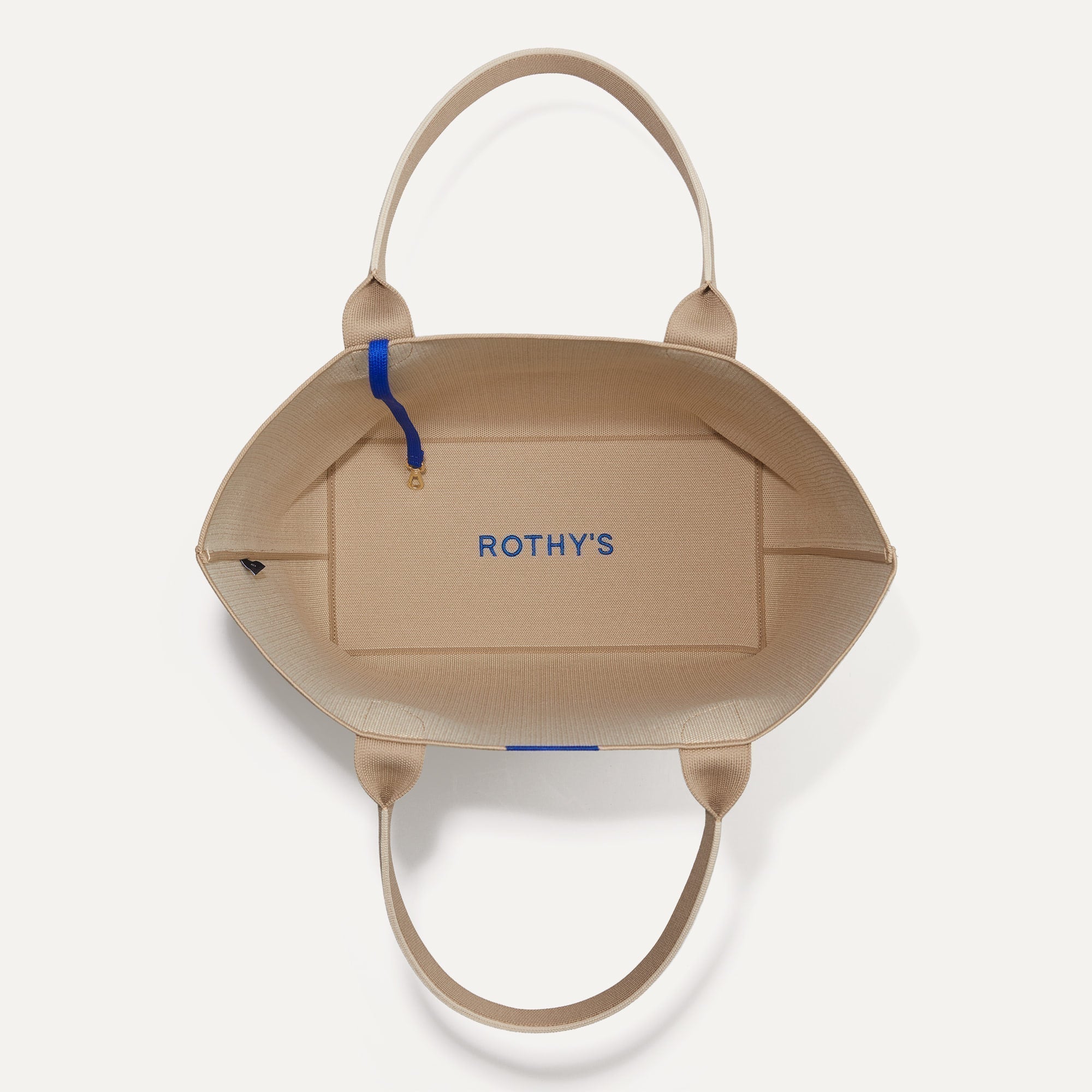 The Lightweight Tote in Soft Sesame shown open from the top, with base insert visible. 