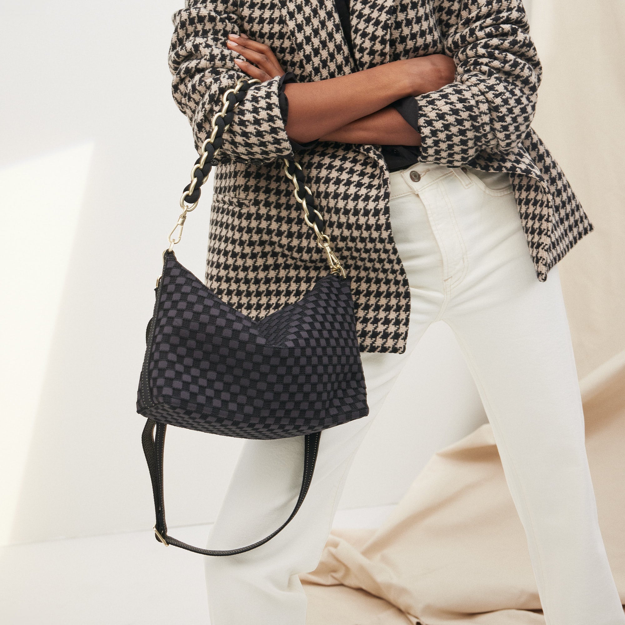hover | Overlay:: Shown with The Shoulder Strap (sold separately.) | Alt:: The Daily Crossbody in Black Sand paired with The Shoulder Strap in Black being carried by a model from a different angle.
