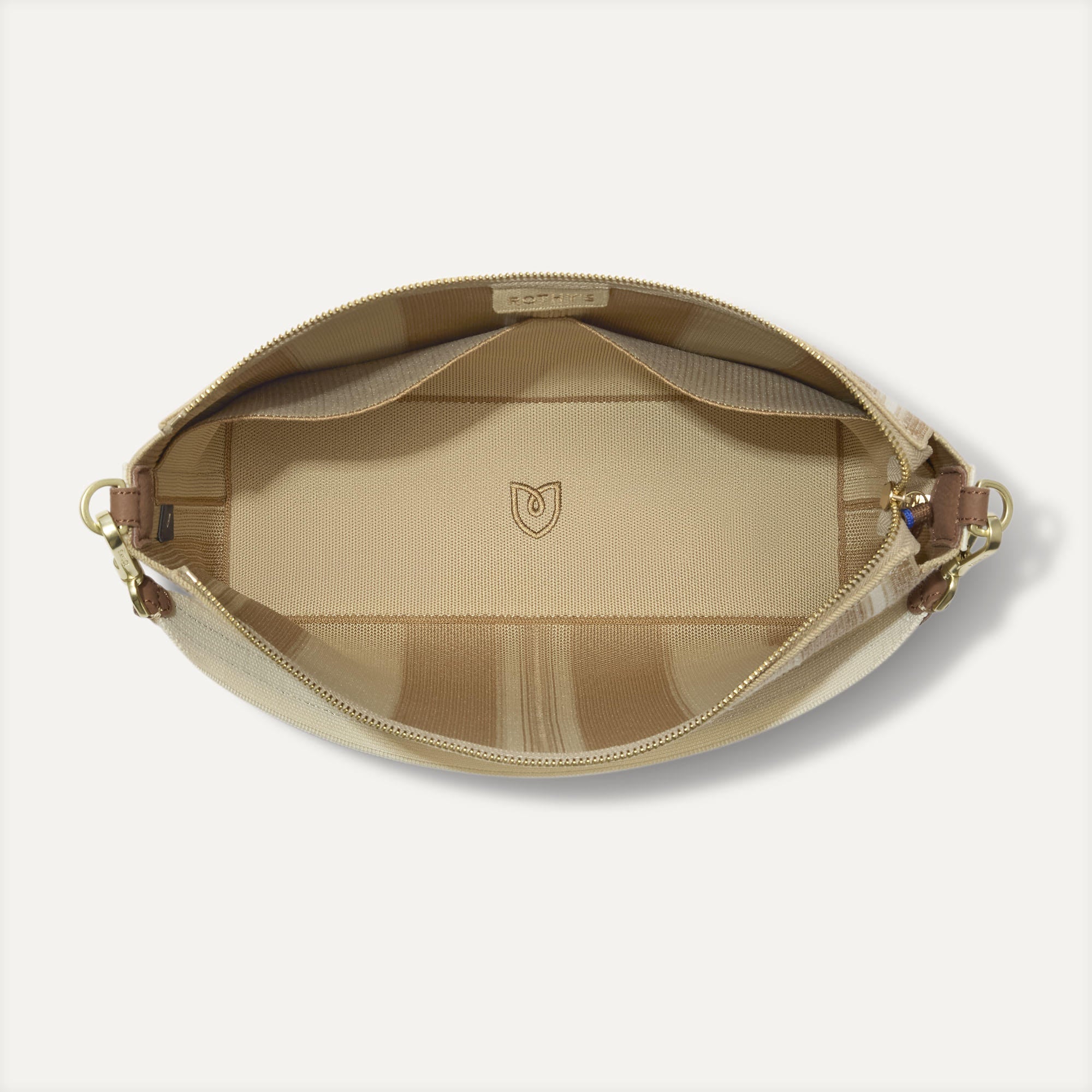 The Daily Crossbody in Oat Latte,  shown from the top down, with zipper open and interior exposed.