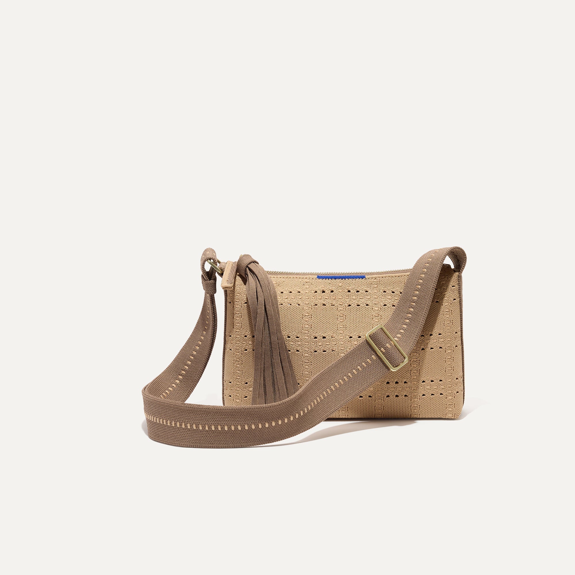 PLP |The Casual Crossbody in Brown Perf, shown from the front.