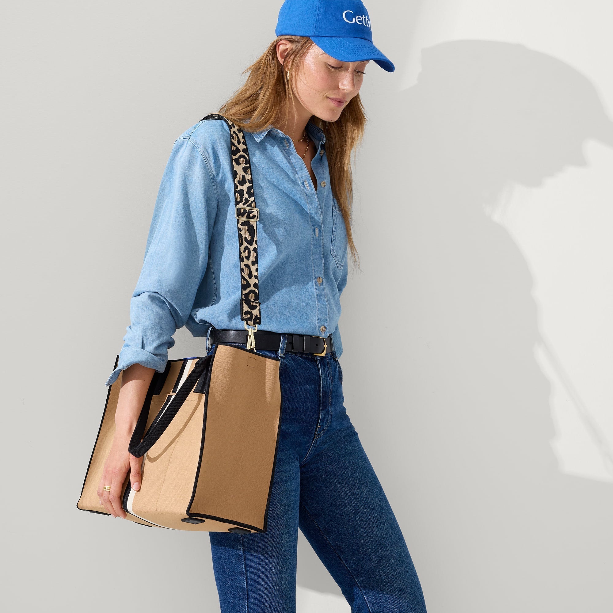 hover | The Crossbody Strap in Desert Cat, shown paired with The Classic Tote, worn by a model, shown from the side