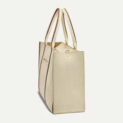 The Classic Tote in Buttercream, shown from the side.