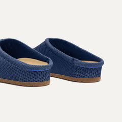 Close up of the heel of The Casual Clog in Blue Raffia-Knit, with Rothy's signature blue halo. 