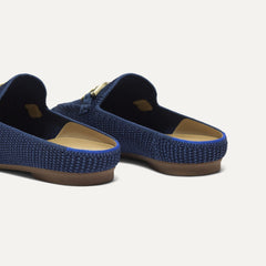 Close up of the heel of The Double Bit Loafer Mule in Blue Raffia-Knit, with Rothy's signature blue halo. 