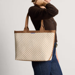 hover | Model holding The Lightweight Zip Tote in Vanilla Wafer.