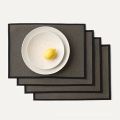A set of four Placemats in Peppercorn shown with a plate setting.