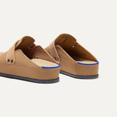 Close up of the heel of The Men's Clog in Butternut, with Rothy's signature blue halo. 