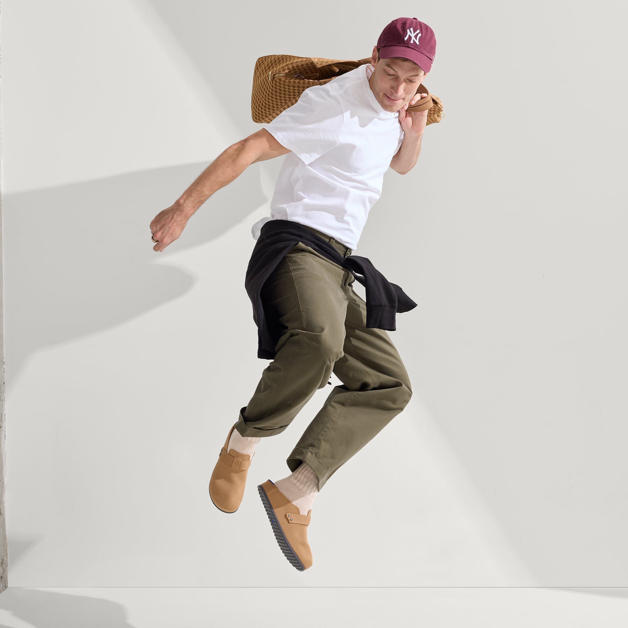 model | Alternate view of a model wearing The Men's Clog in Butternut. 