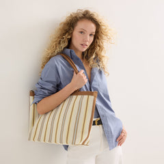 hover | Model holding The Lightweight Zip Tote in Sunbeam Market Stripe.