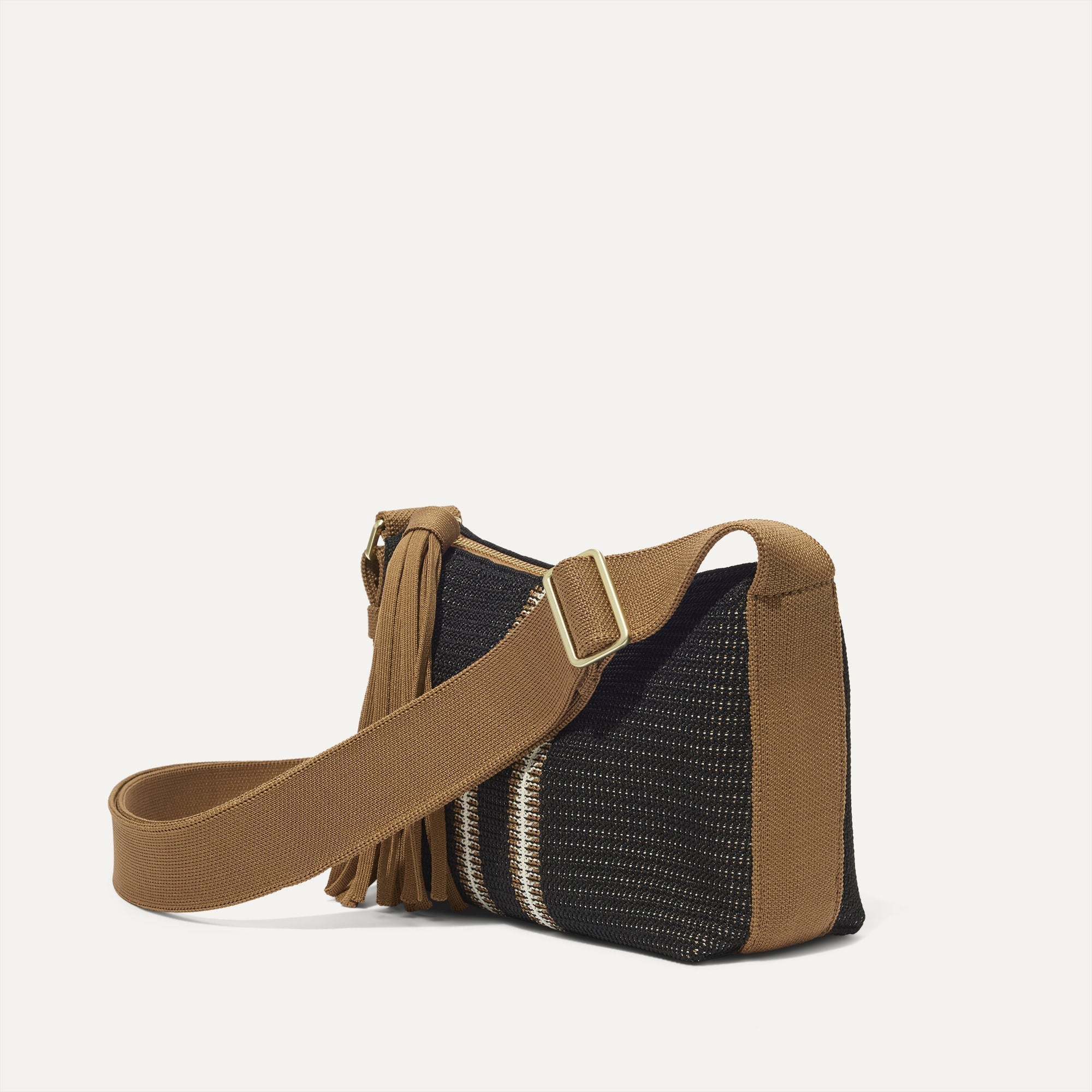The Casual Crossbody in Coffee Market Stripe, shown from the side at an angle.