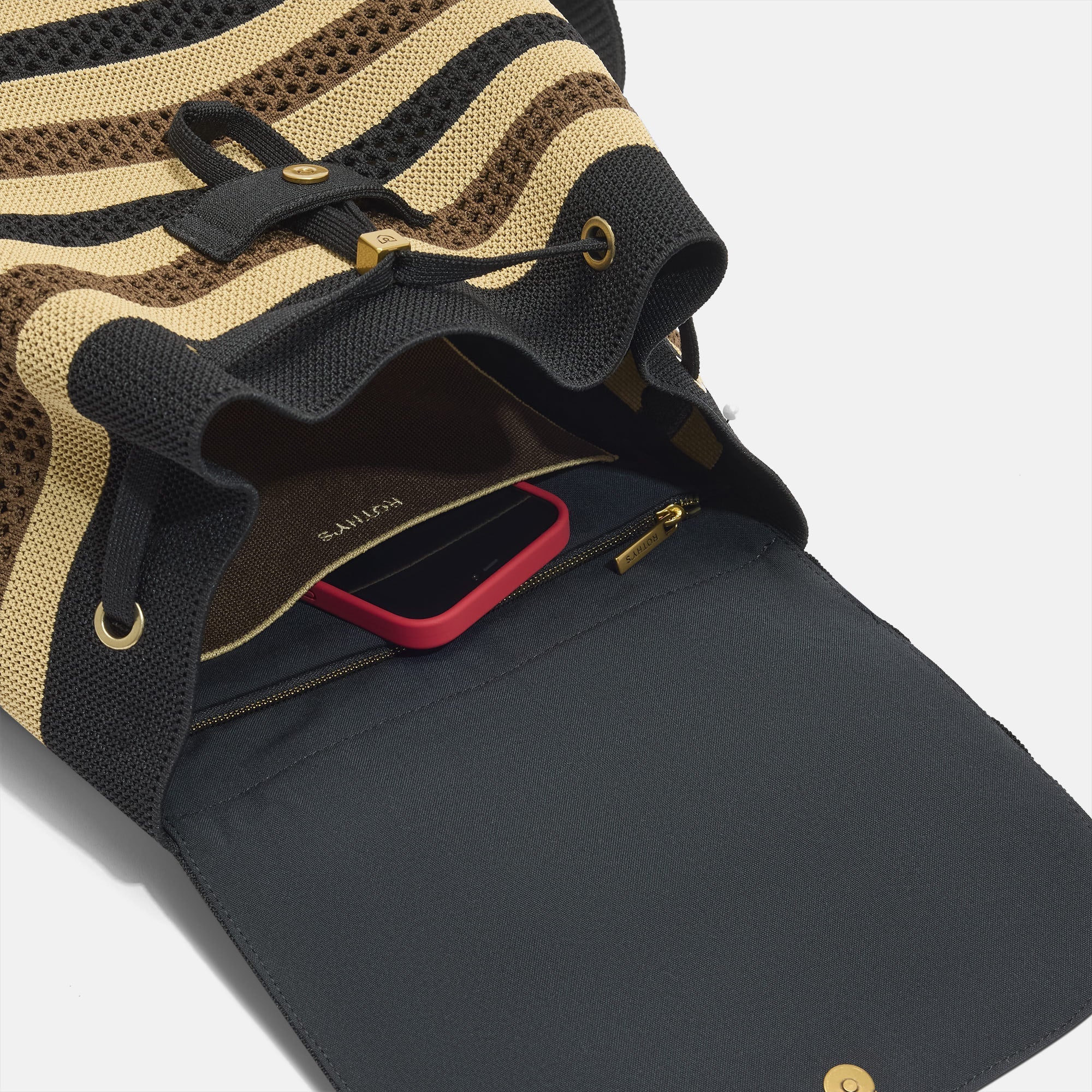 A close up of the interior pocket on The Cinch Backpack in Mocha Stripe Crochet