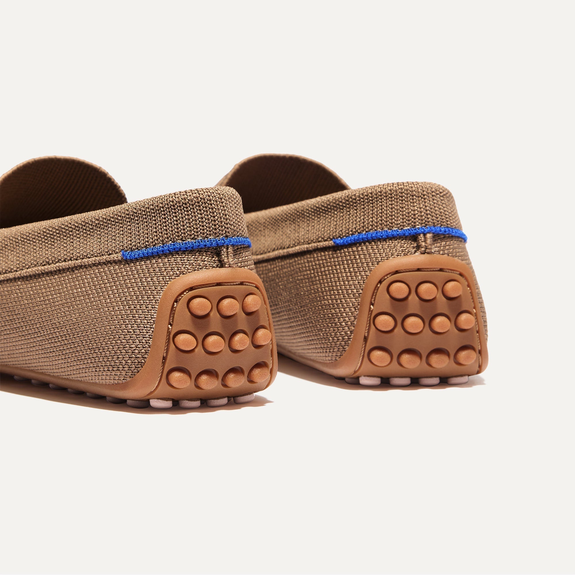 Close up of the heel of The Daily Driver in Portobello, with raised peg outsoles and Rothy's signature blue halo. 