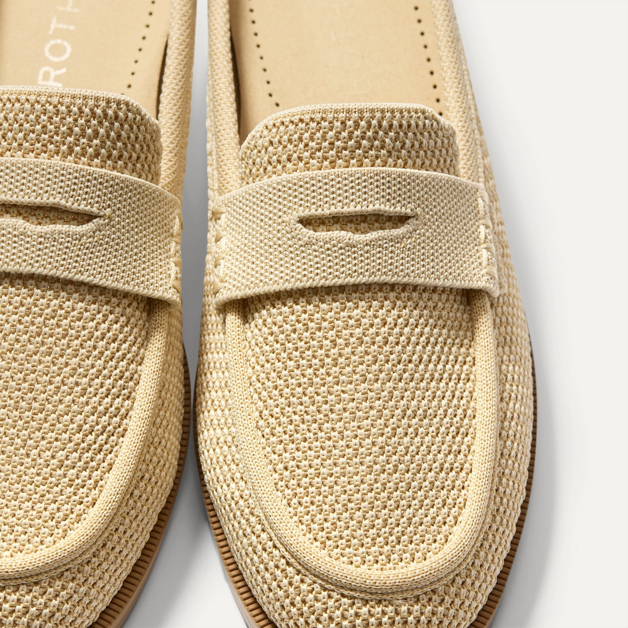 Close up of the toe and vamp of The Penny Loafer Mule in Sandstone Raffia-Knit, showing the penny keeper detail.