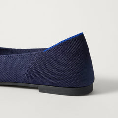 Close up of the heel of The Point III in Navy, with Rothy's signature blue halo. 