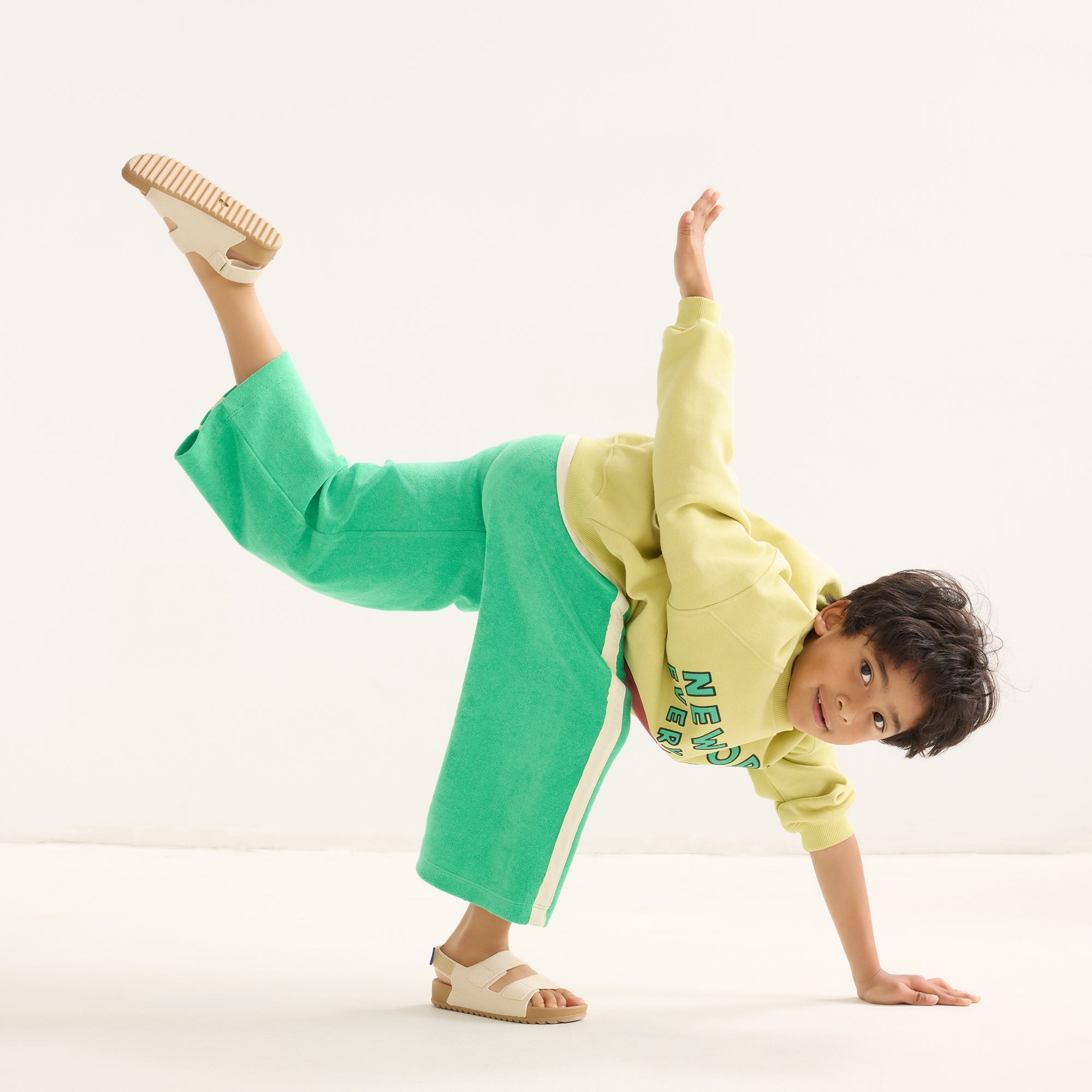 model | Alternate view of a boy wearing The Kids Double Strap Sandal in Conch.
