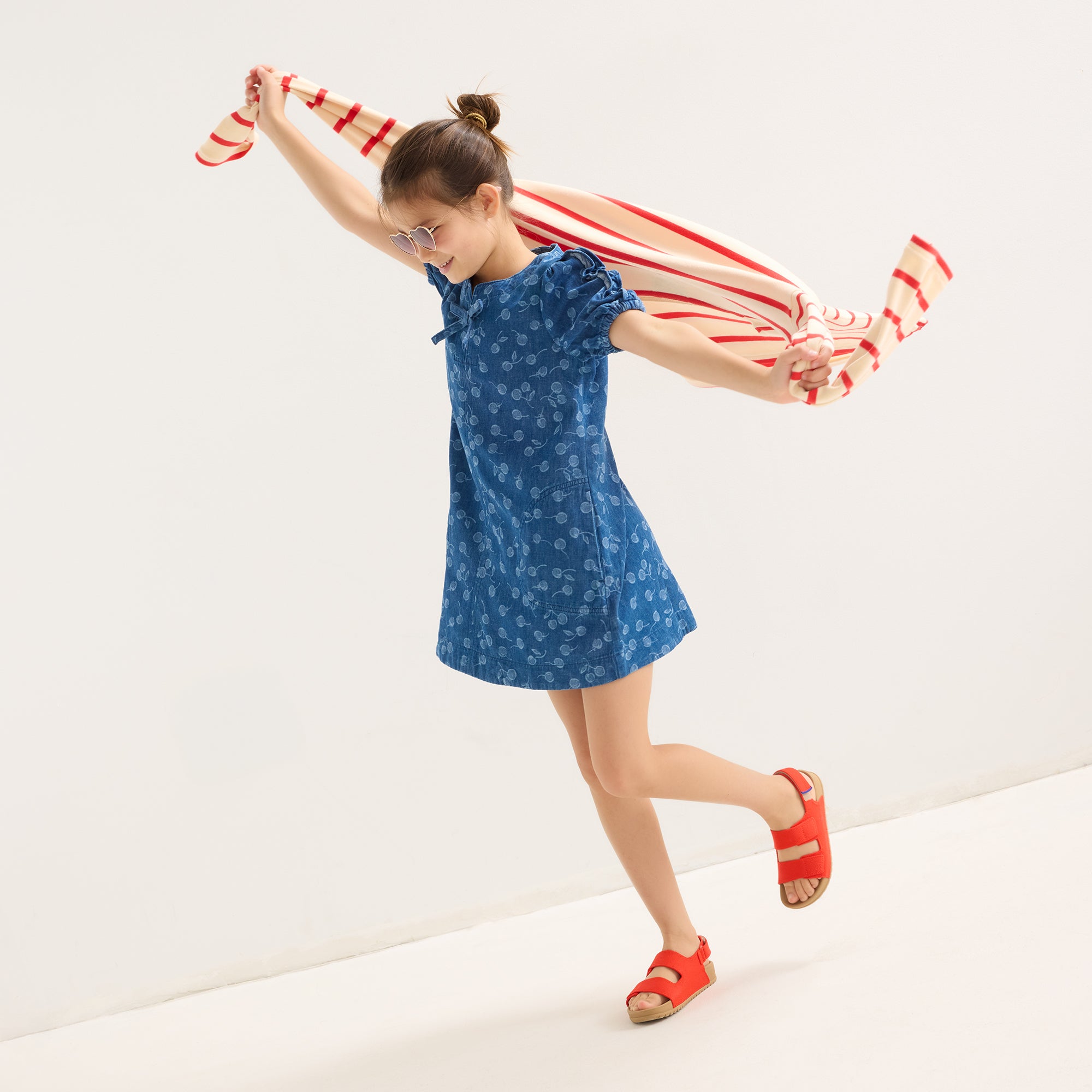 hover | Model wearing The Kids Double Strap Sandal in Firetruck Red.