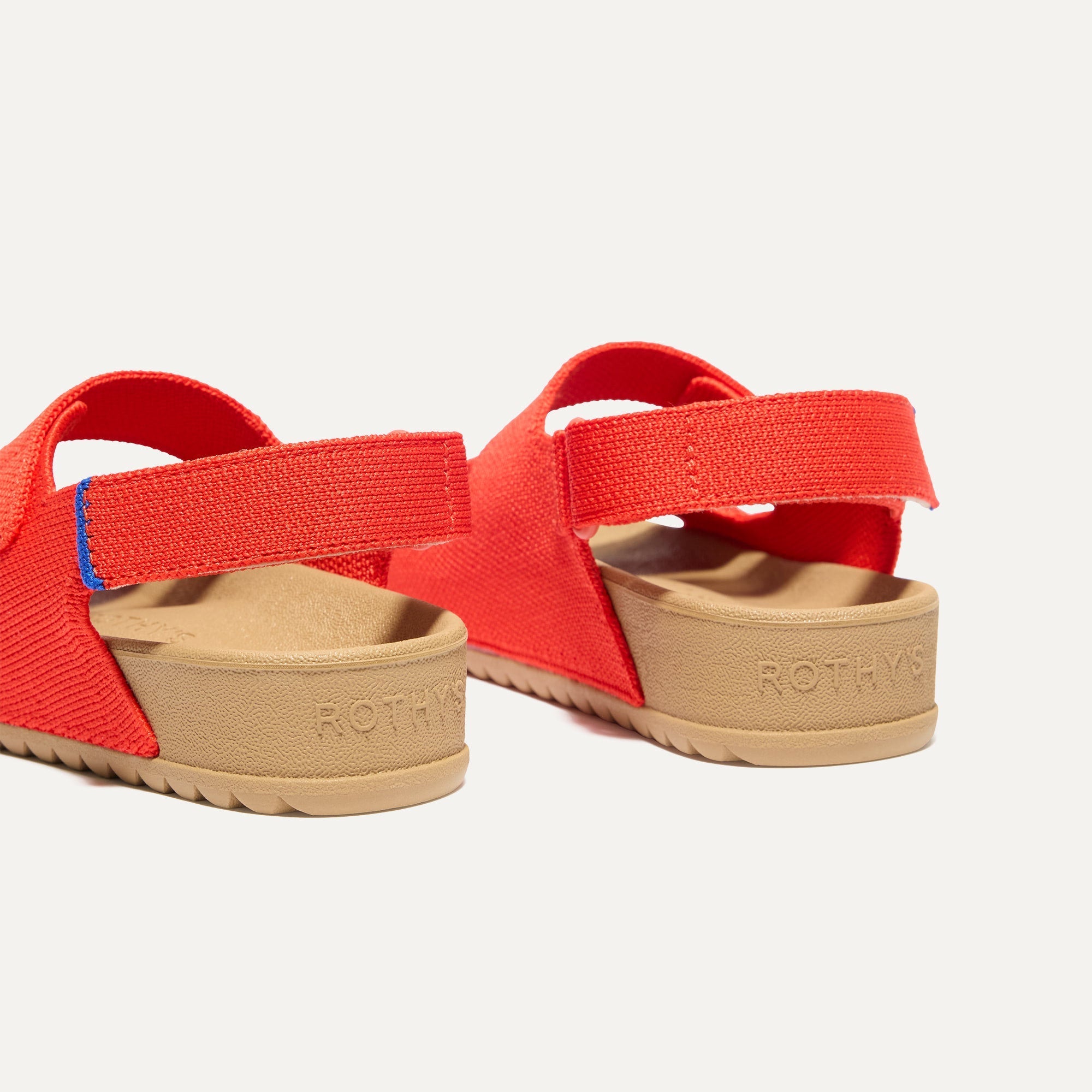 Close up of the heel strap on The Kids Double Strap Sandal in Firetruck Red.