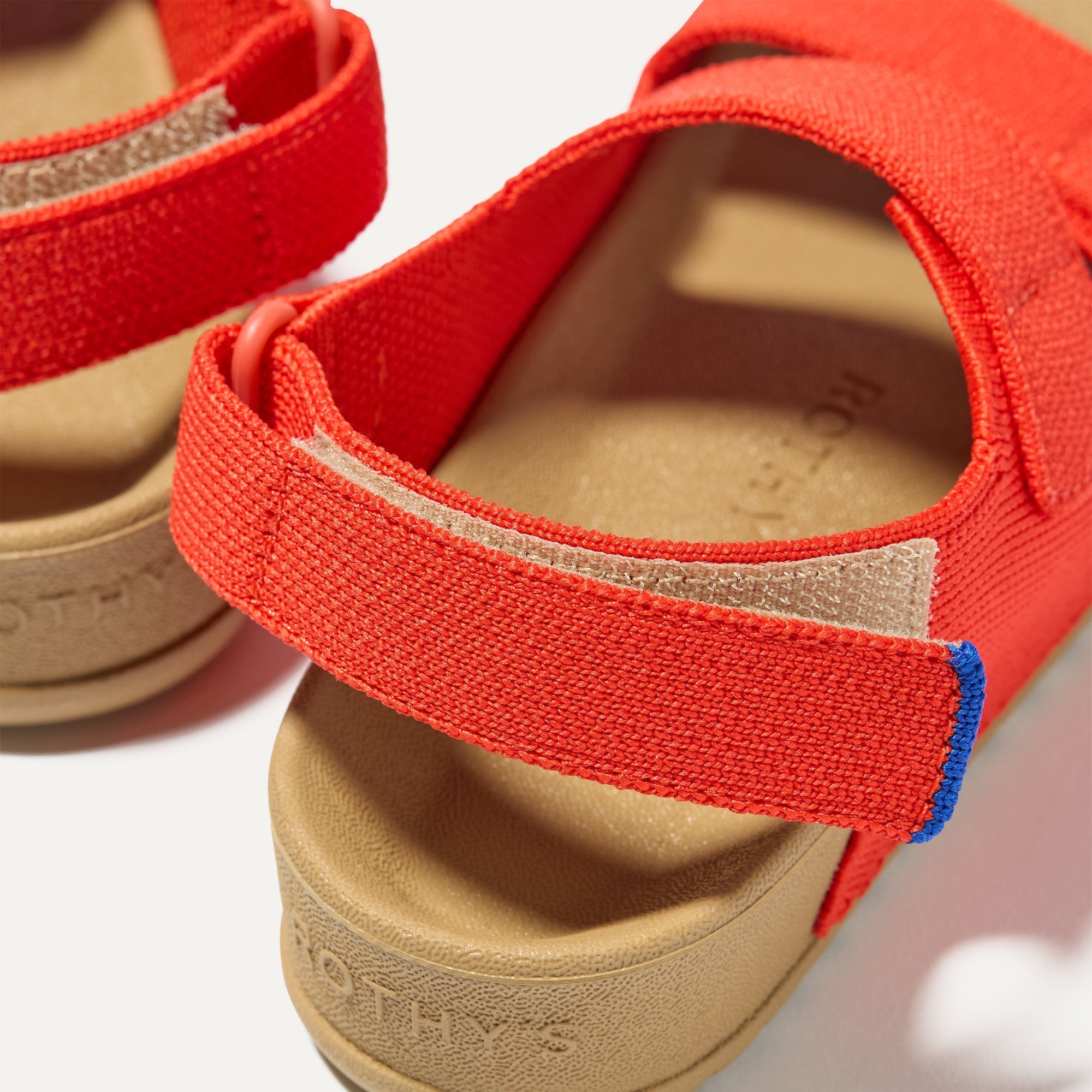 Close up of the velcro heel strap on The Kids Double Strap Sandal in Firetruck Red.