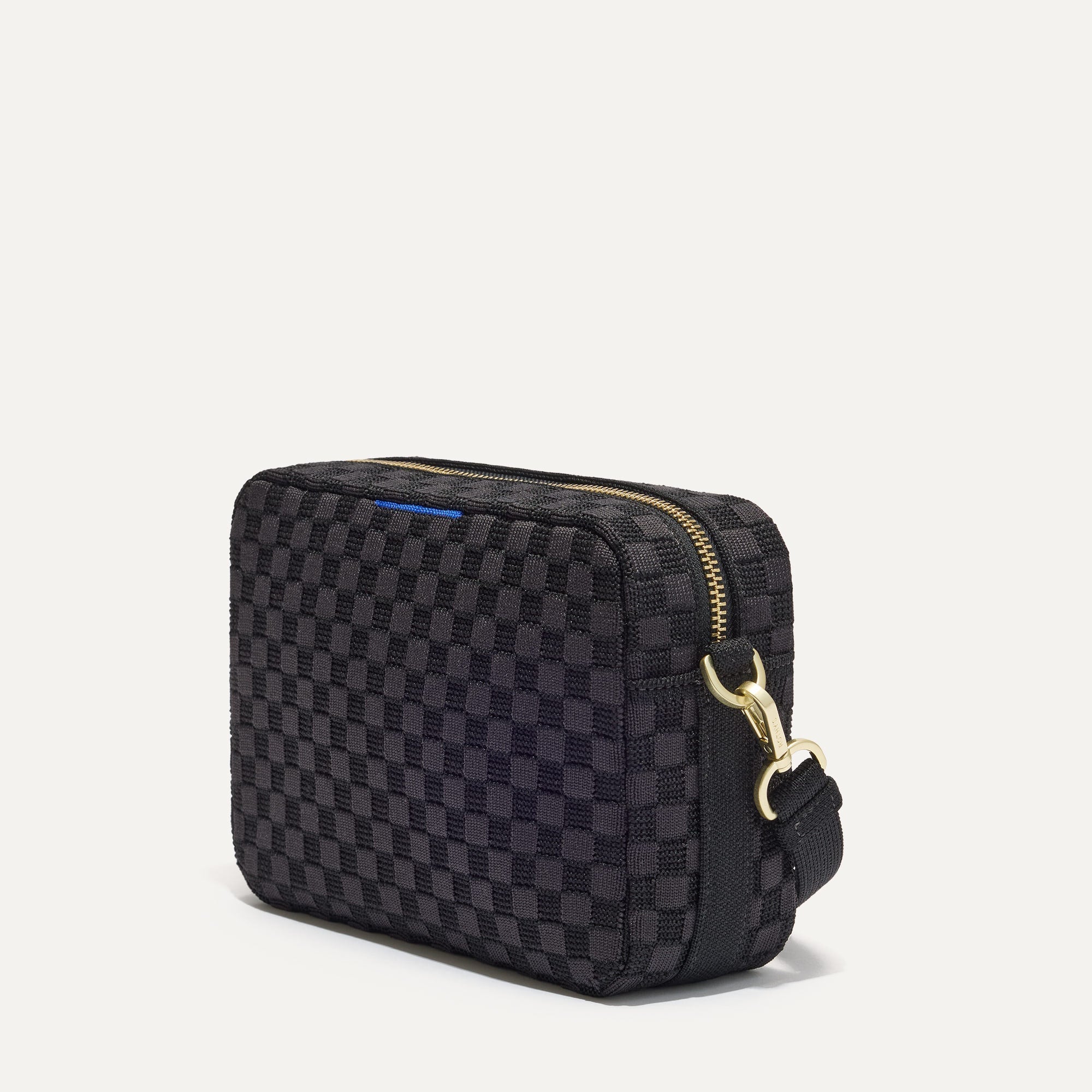 The Crossbody Camera Bag in  Black Sand, shown from the side. 