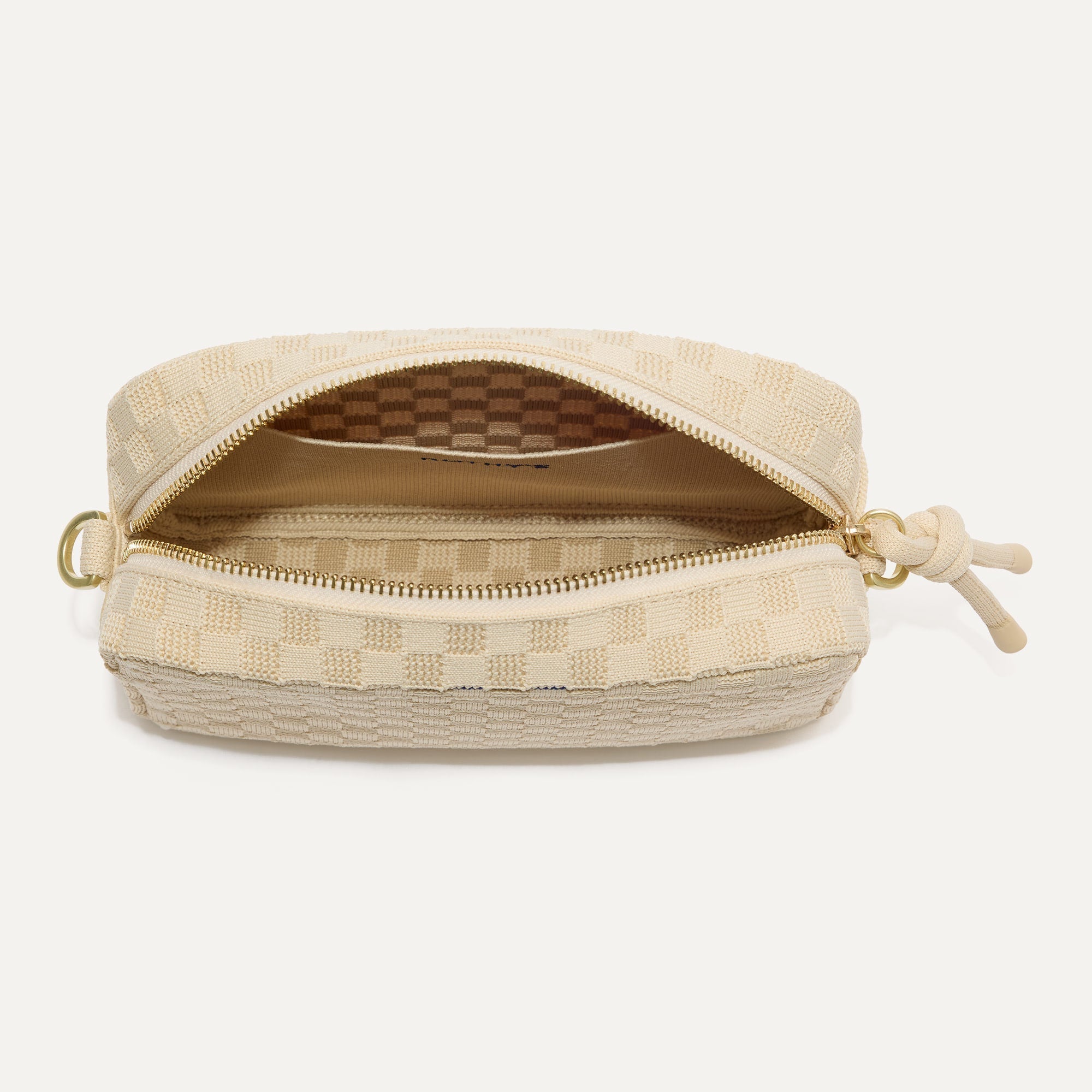 The Crossbody Camera Bag in Sesame, shown from above, with the interior exposed.