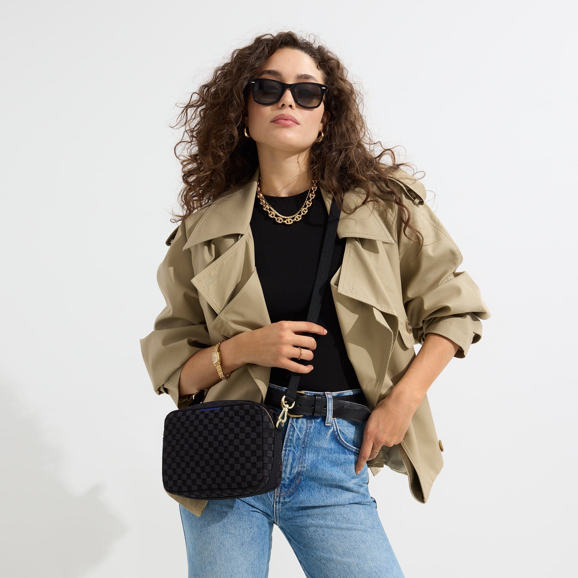 hover | The Crossbody Camera Bag in  Black Sand worn as a crossbody by a model.
