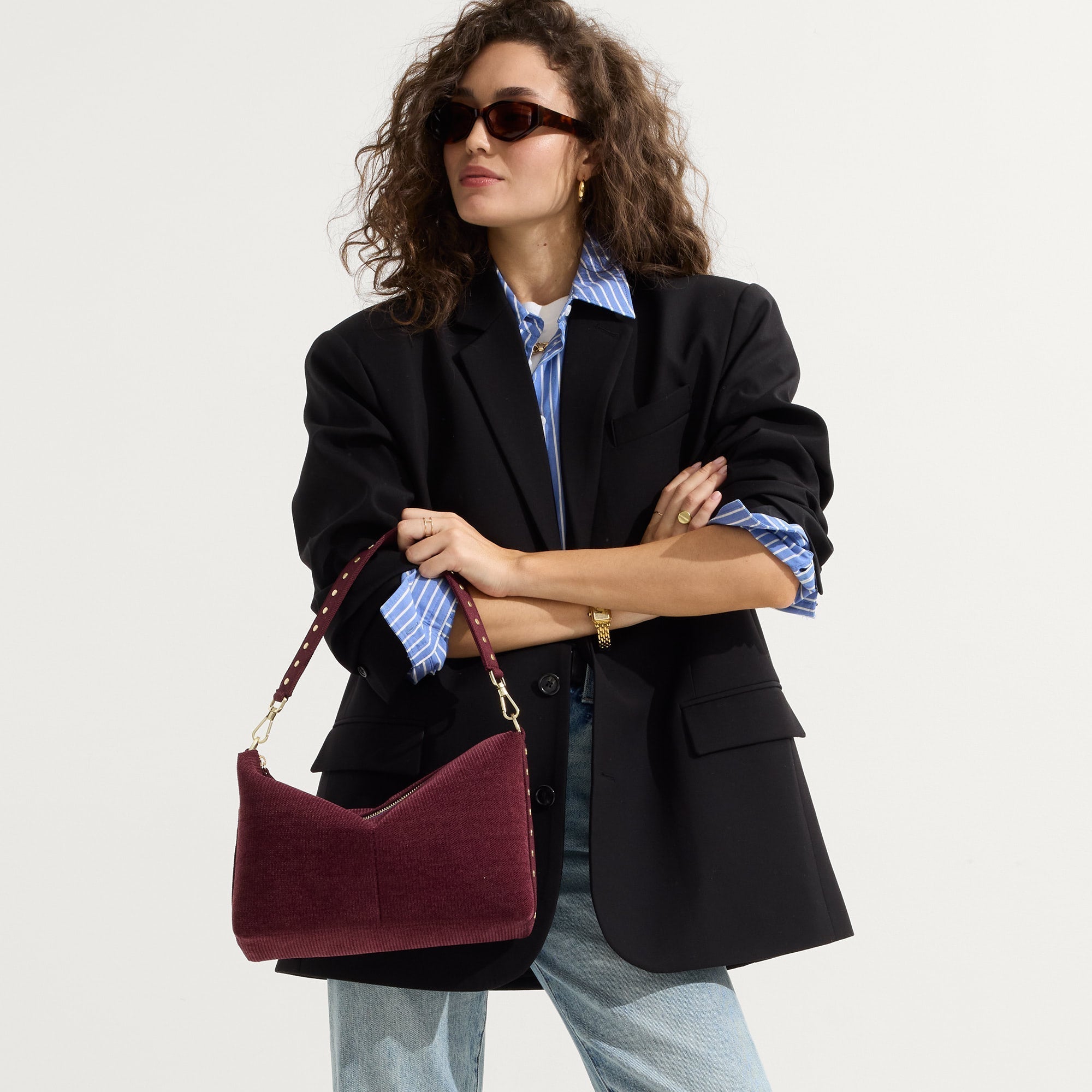 hover | The Daily Crossbody in ReVelvet™ Syrah , carried over the shoulder of a female model, shown from the right.