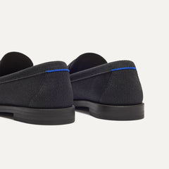 Close up of the heel of The Penny Loafer in Black, with Rothy's signature blue halo. 