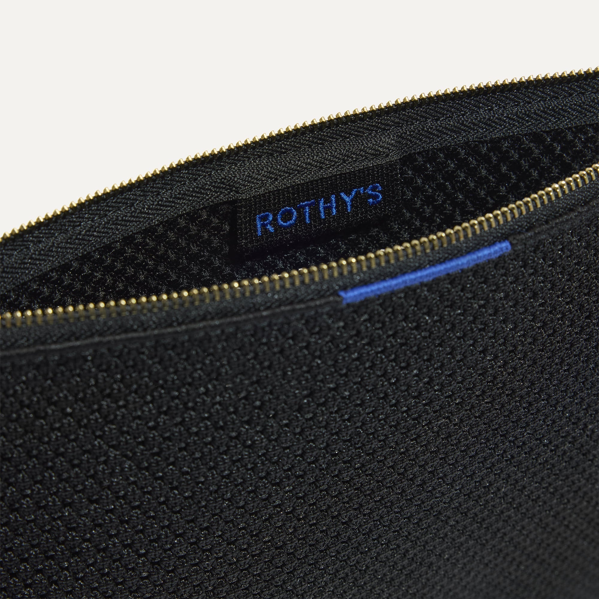 The Convertible Clutch in Black Espresso Open-Knit, shown open from the top in diagonal view.
