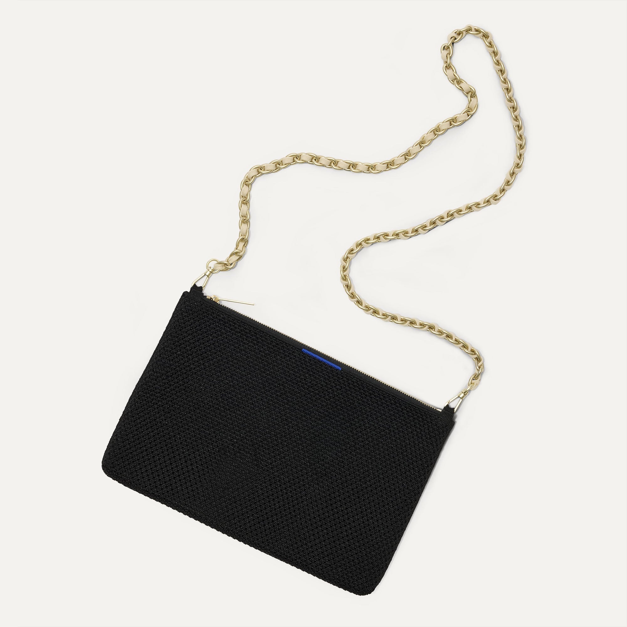 Overlay:: Shown with The Crossbody Strap (sold separately). | Alt:: An image of The Convertible Clutch in Black Espresso Open Knit paired with The Crossbody Strap.