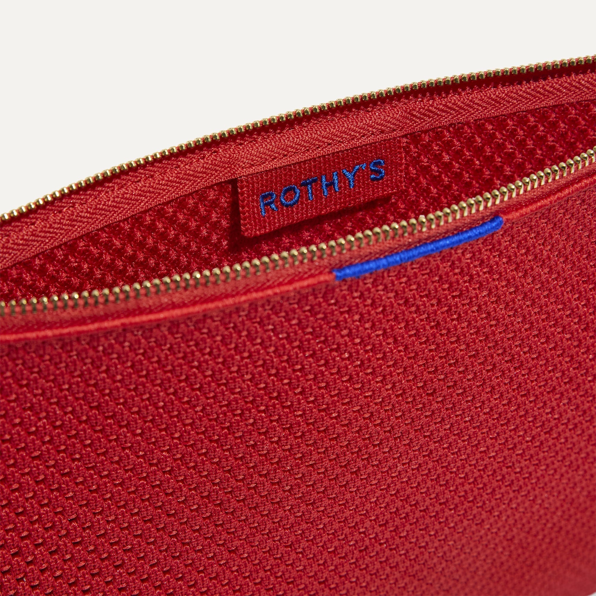 The Convertible Clutch in Scarlet Open-Knit, shown open from the top in diagonal view.