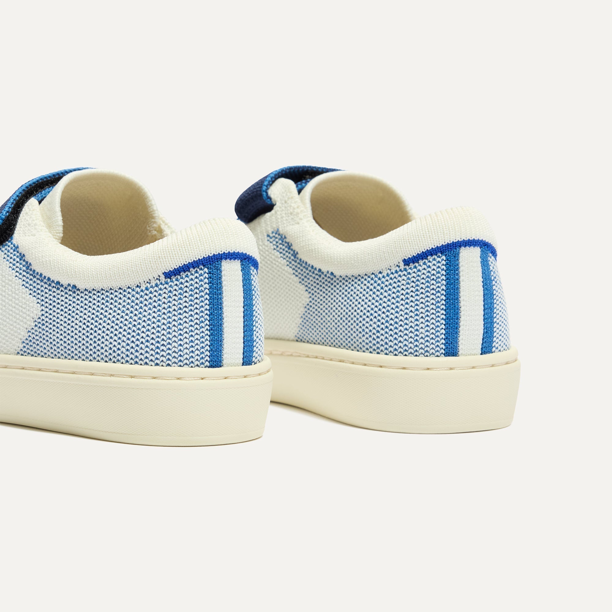 Close up of the heel of The Kids Strap Sneaker in Blue Raspberry, with Rothy's signature blue halo. 
