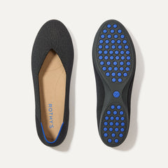 PLP |The Daily Flat in Black shown from the top with one shoe showing the outsole. 
