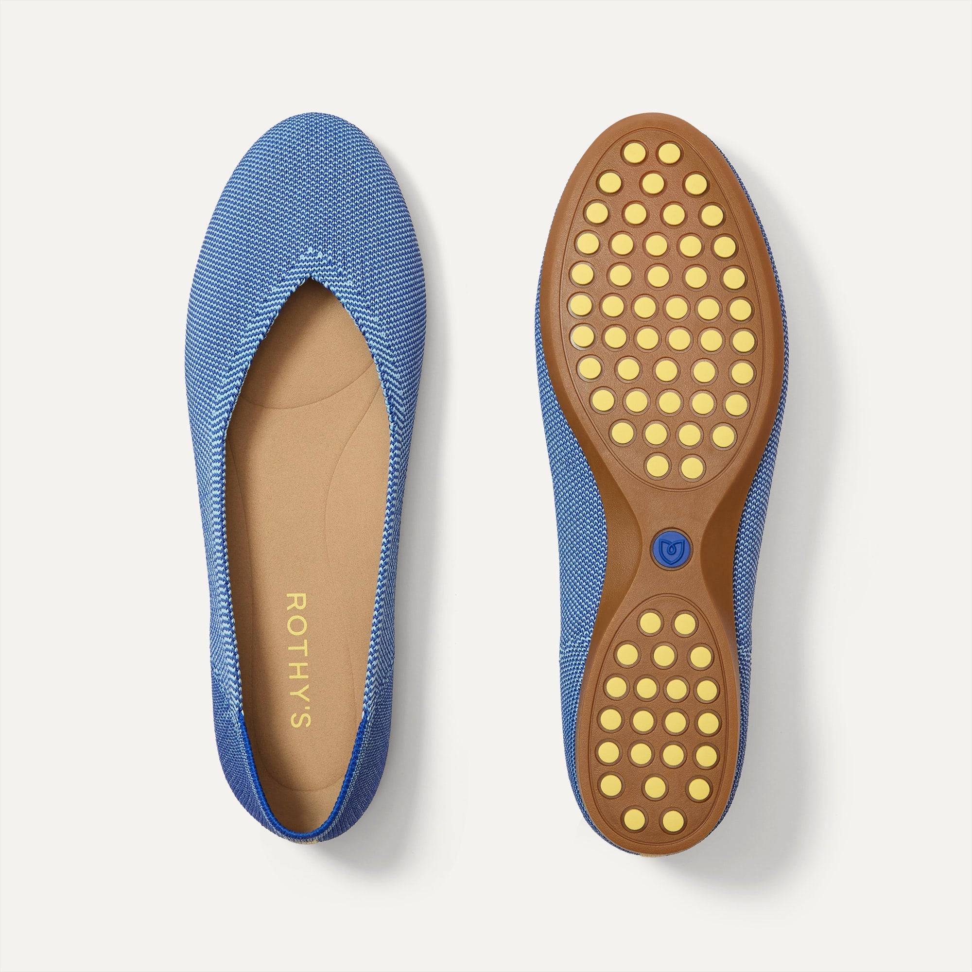 PLP |The Daily Flat in Clear Blue shown from the top with one shoe showing the outsole. 