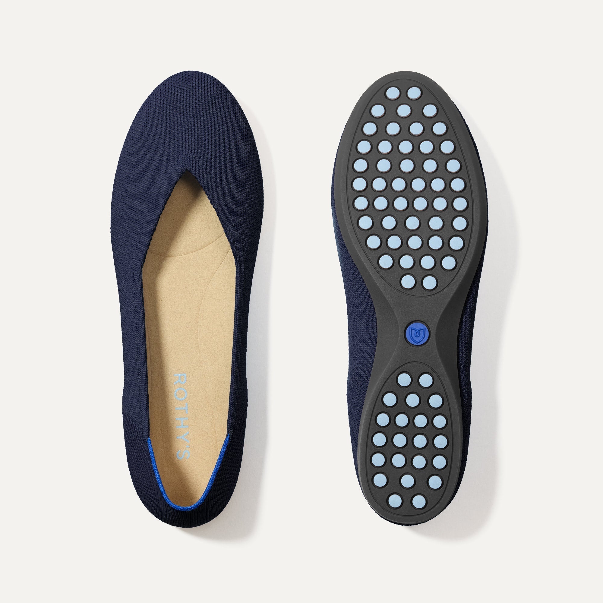 PLP |The Daily Flat in Navy shown from the top with one shoe showing the outsole. 