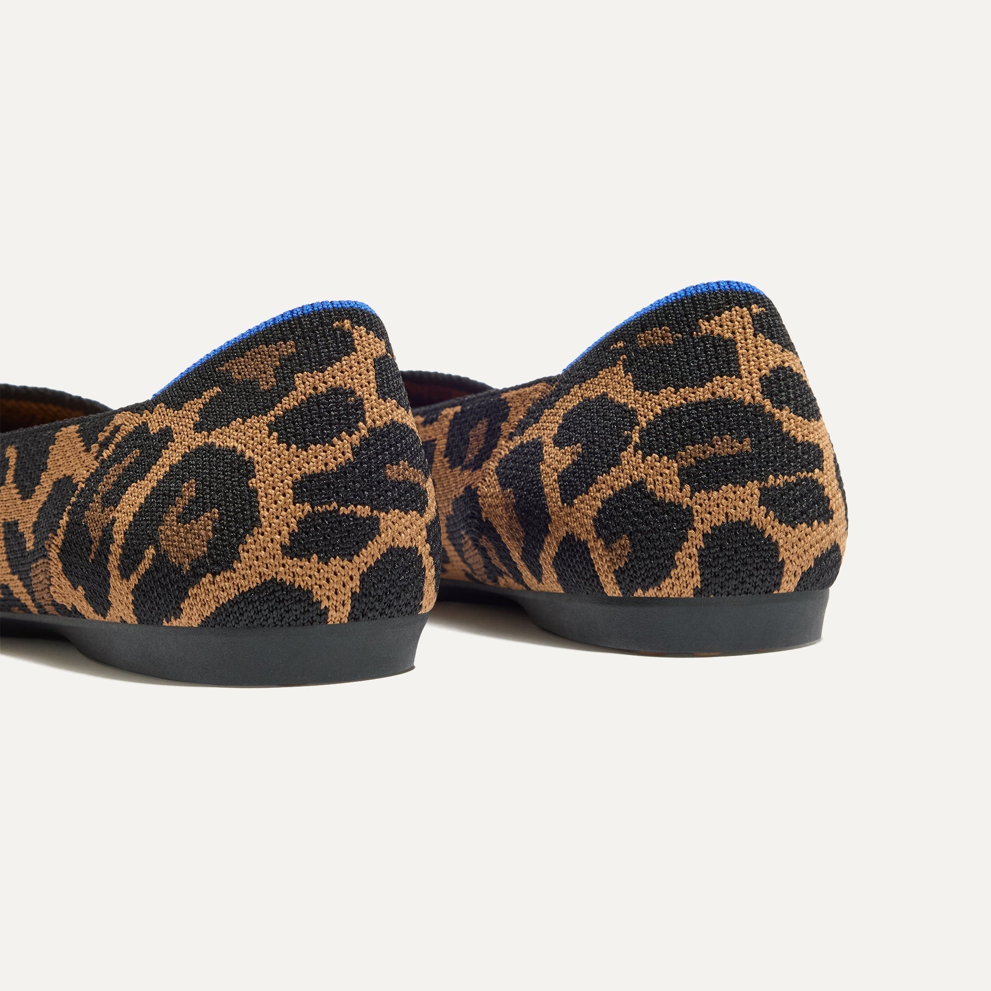 Close up of the heel of The Daily Flat in Sable Spot, with Rothy's signature blue halo. 