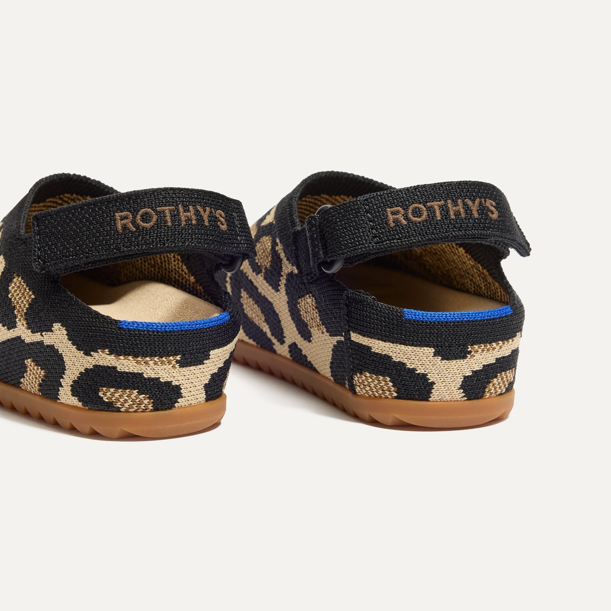 Close up of the heel of The Kids Clog in Desert Cat, with Rothy's signature blue halo. 