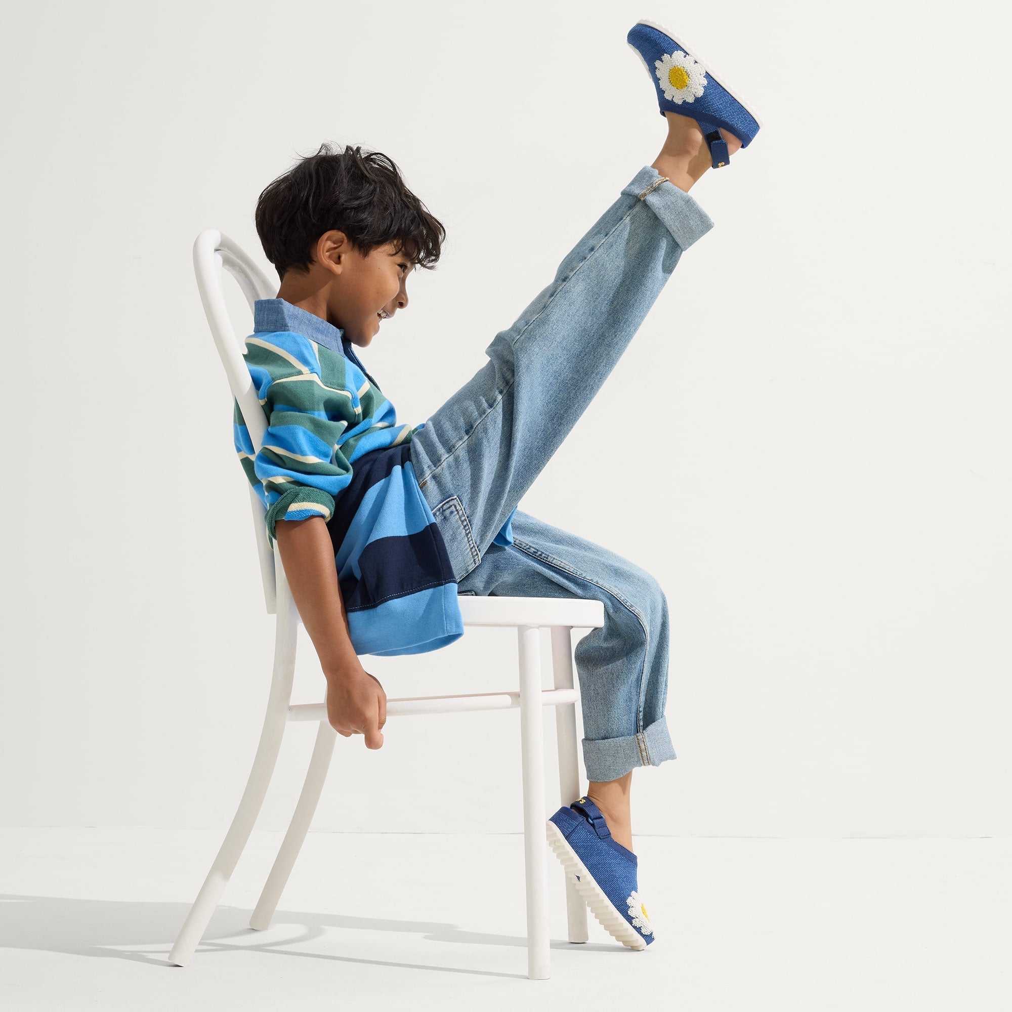 model | Alternate view of a child wearing The Kids Clog in Indigo Daisy. 