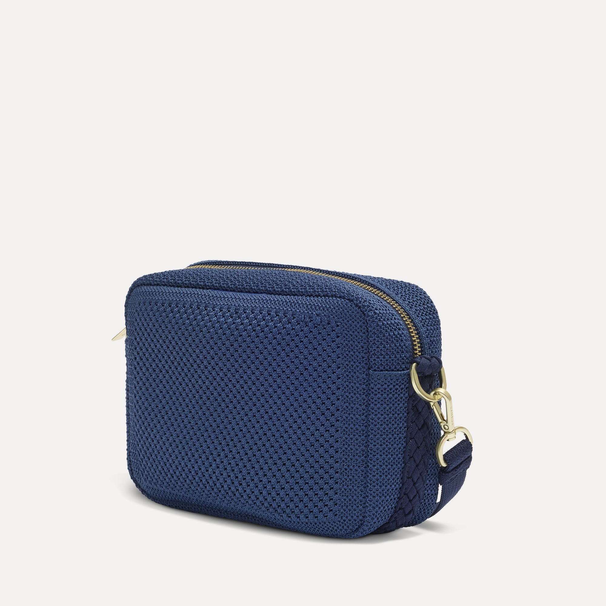 The Crossbody Camera Bag in  Lagoon Open-Knit, shown from the side. 