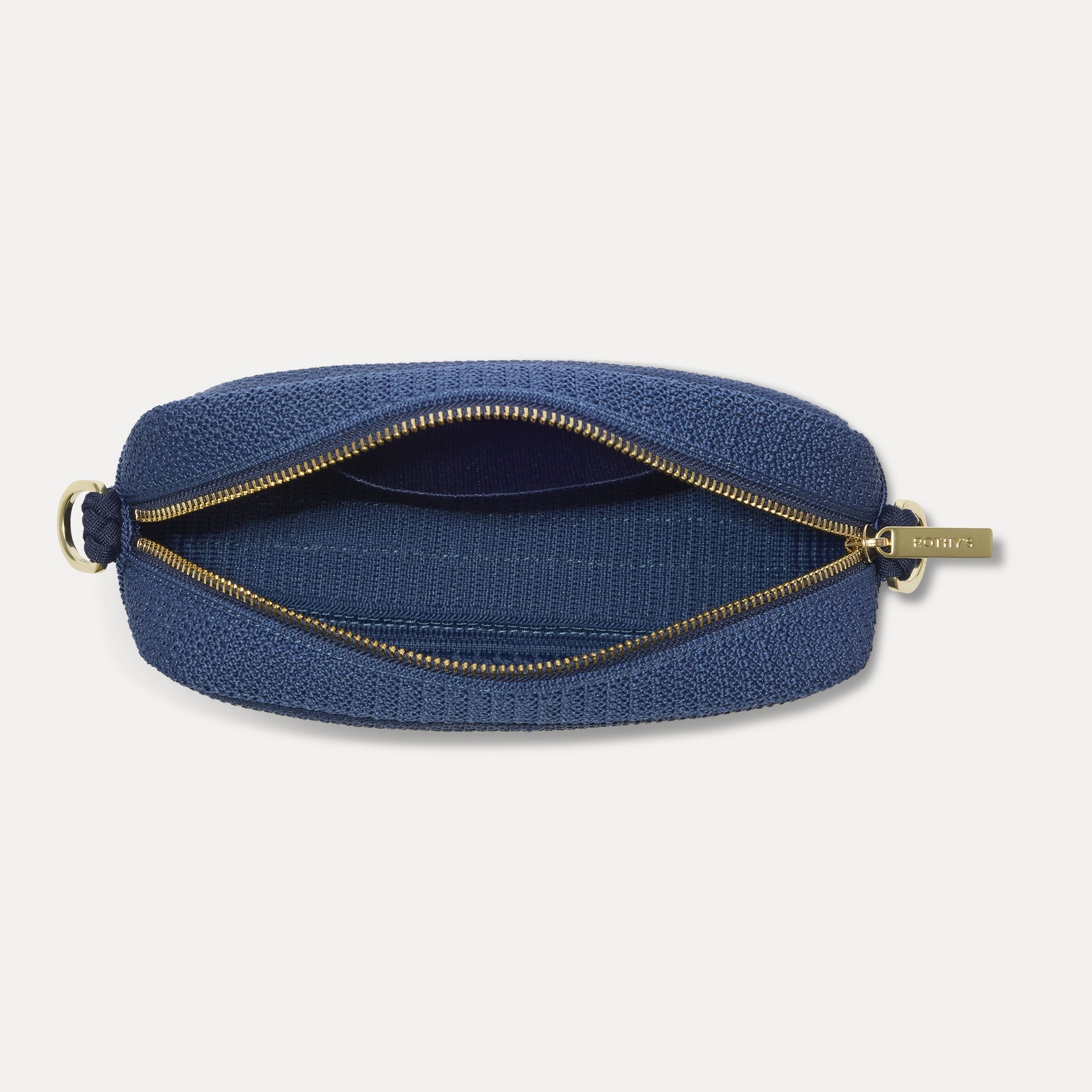The Crossbody Camera Bag in Lagoon Open-Knit, shown from above, with the interior exposed.