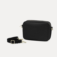 The Crossbody Camera Bag in Black Licorice Open-Knit shown by itself with removable strap. 