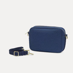 The Crossbody Camera Bag in Lagoon Open-Knit shown by itself with removable strap. 
