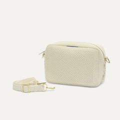 The Crossbody Camera Bag in Cream Twist Open-Knit shown by itself with removable strap. 