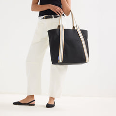 hover | Model wearing The Travel Tote in Ink shown from the front.