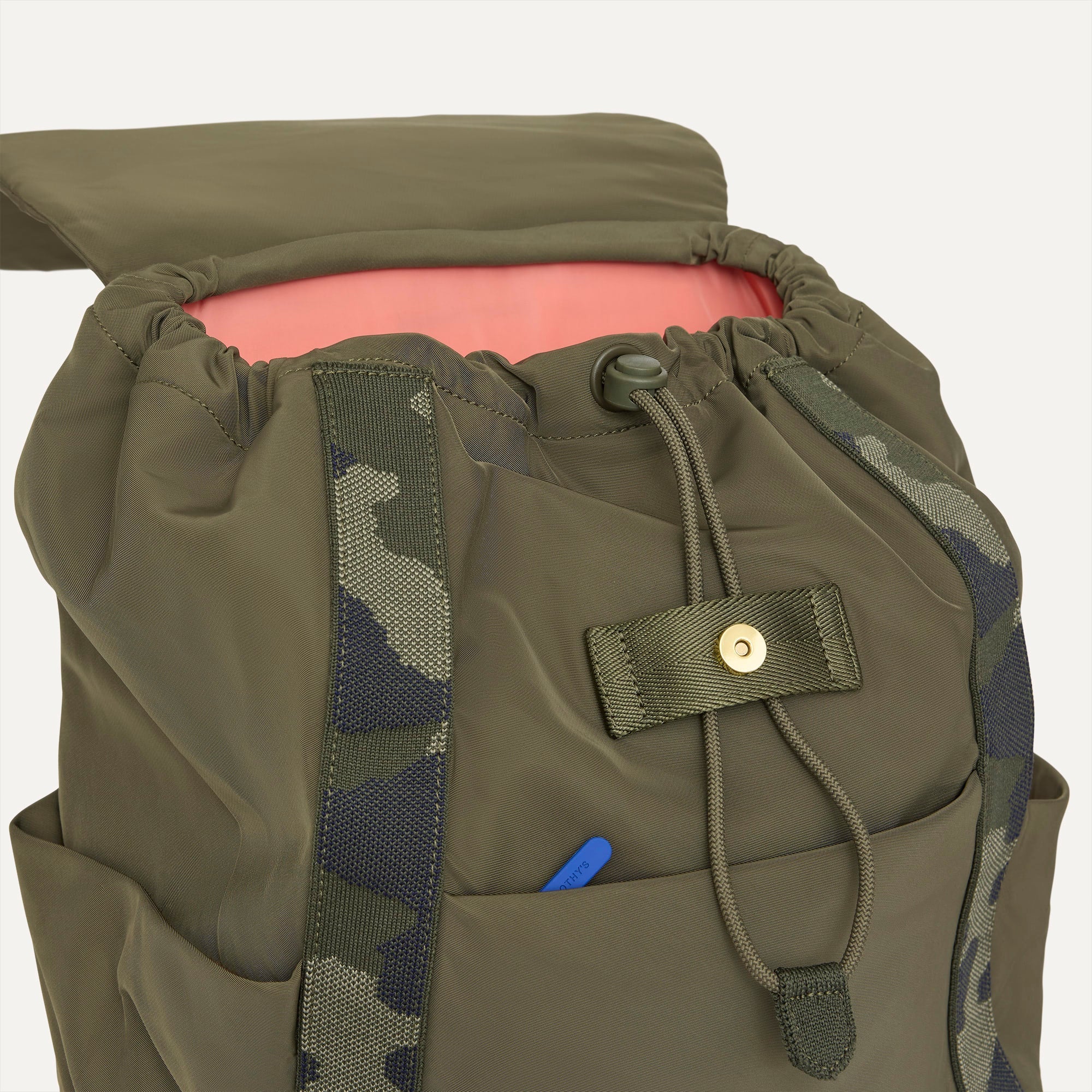 A close up of The Travel Cinch Backpack in Forest showing the drawstring closure.