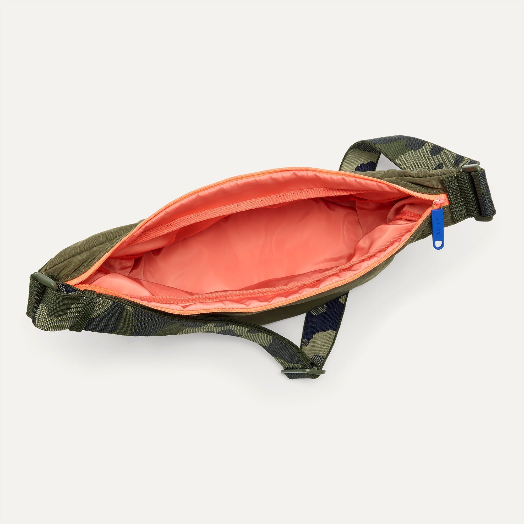 The Travel Sling in Forest shown from the top down, with zipper open and interior exposed.